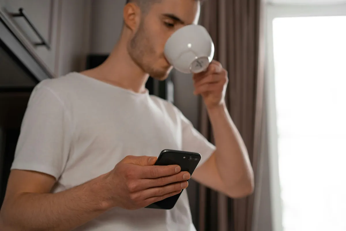 Person reading journal entries on phone while sitting with coffee