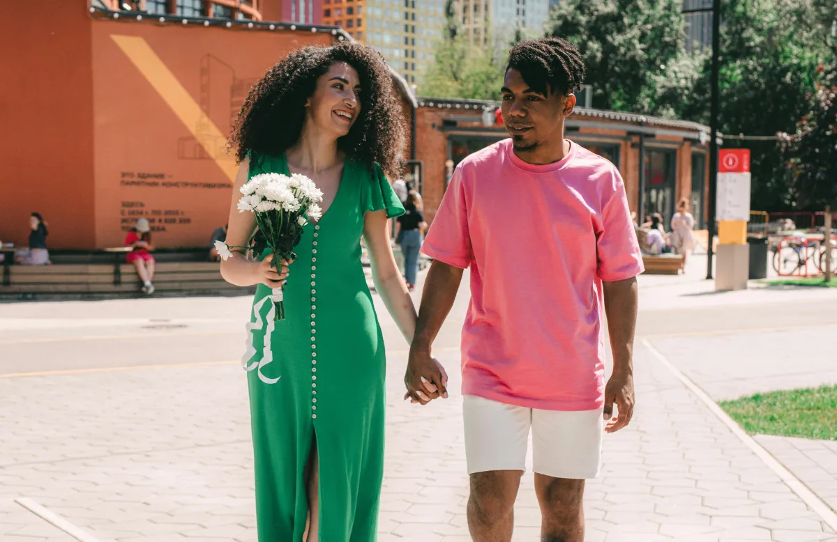 Couple walking together sharing a private moment outdoors, private sharing couples